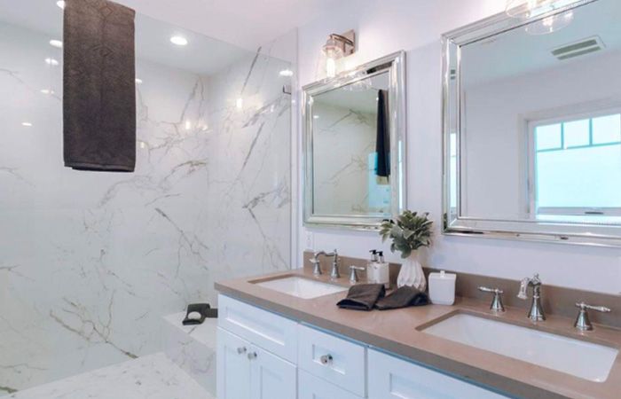Primary bathroom remodel with a white vanity and brown countertops by general contractor in Walnut Creek, CA.